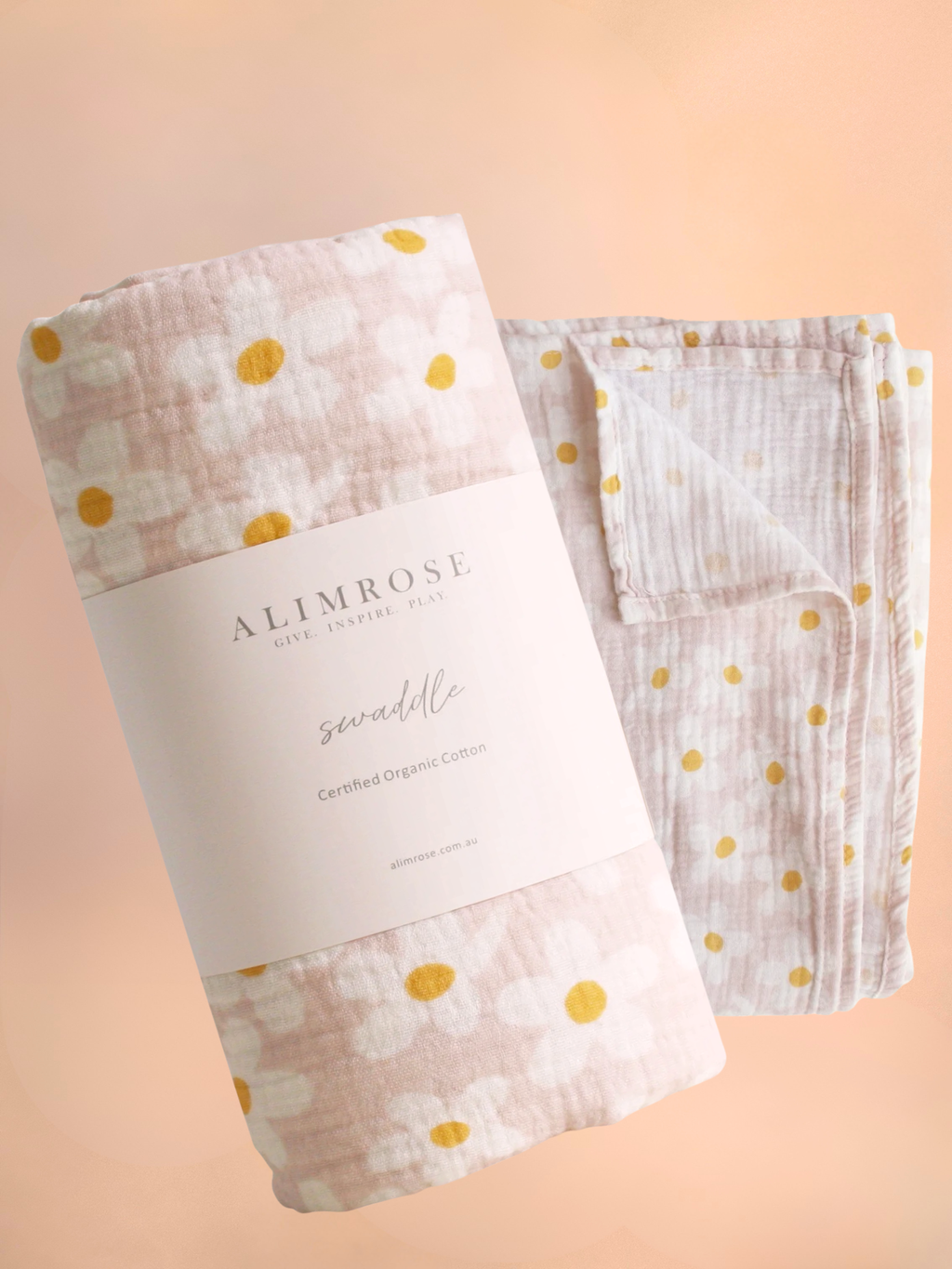 Two folded muslin cloths with gold polka dots and a visible 'Alimrose' label on a peach background, Flowers Gold Coast.