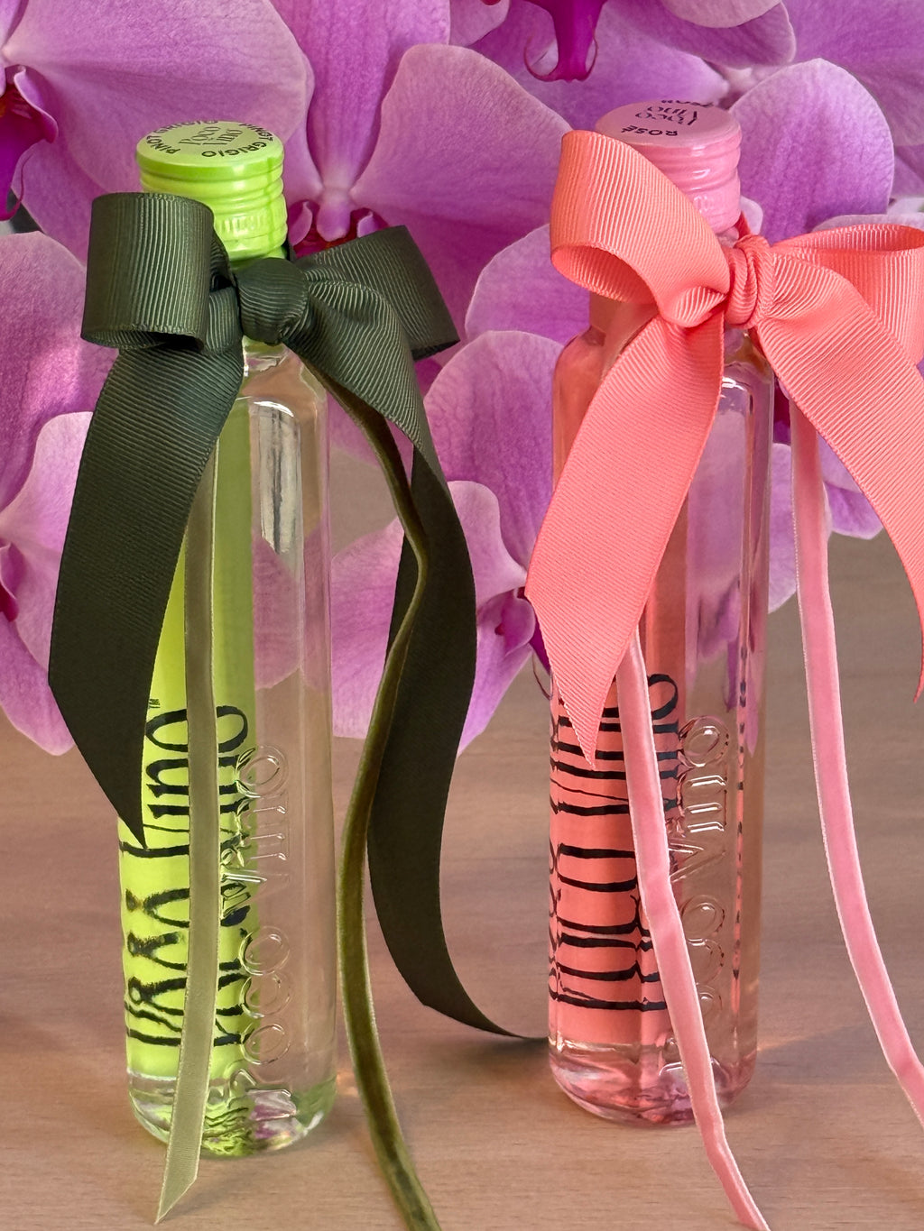Two clear bottles with colorful ribbons on a pink floral background, Poco Vino, Flowers Gold Coast