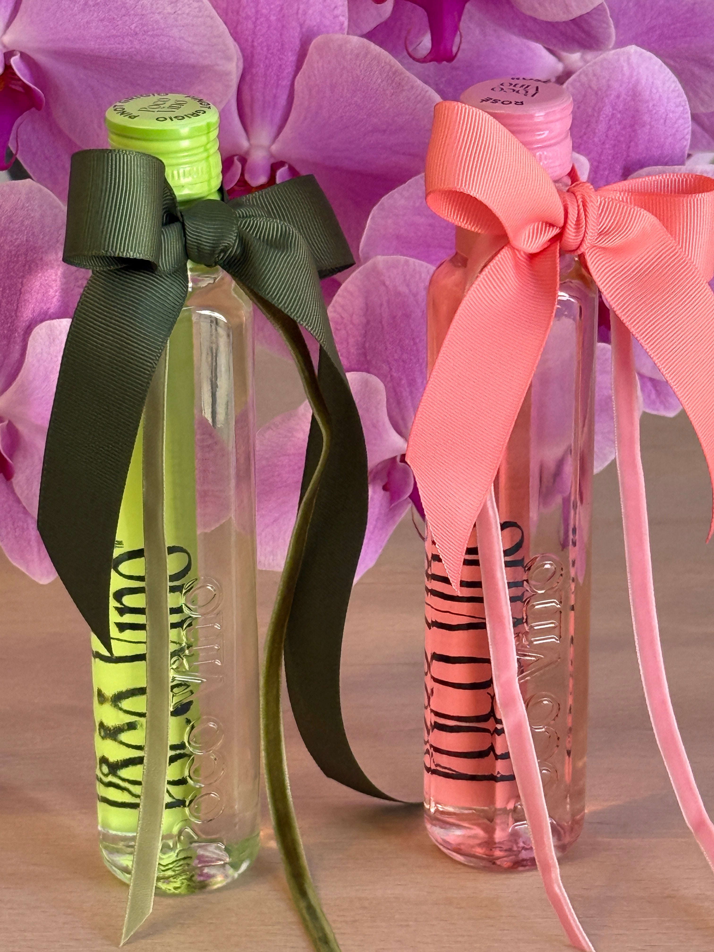 Two clear bottles with colorful ribbons on a pink floral background, Poco Vino, Flowers Gold Coast