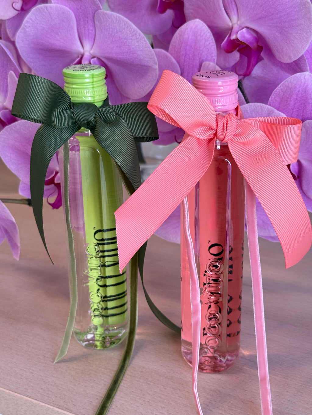 Two small bottles with colorful bows on a background of purple flowers, Poco Vino, Flowers Gold Coast.