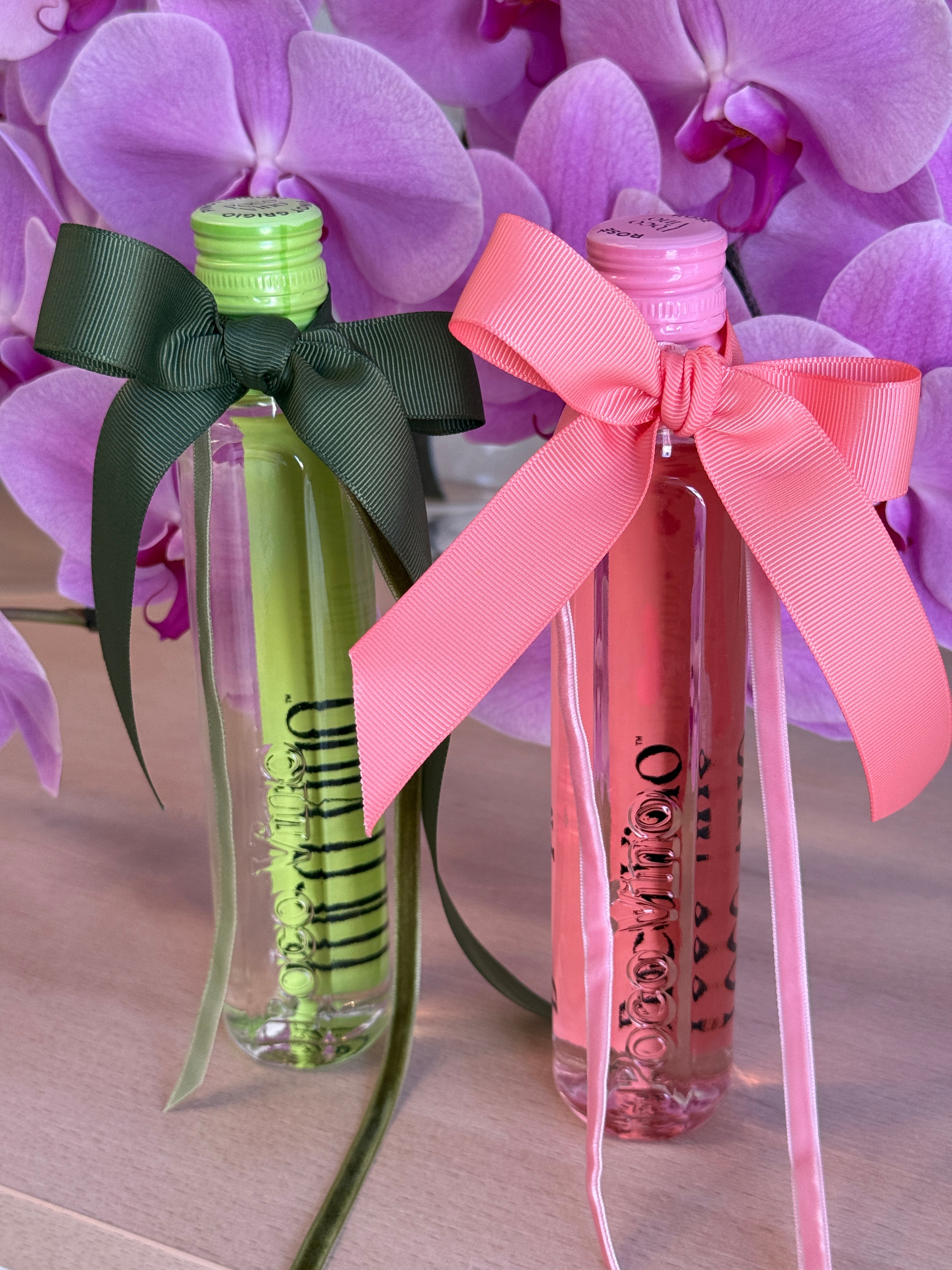 Two small bottles with colorful bows on a background of purple flowers, Poco Vino, Flowers Gold Coast.